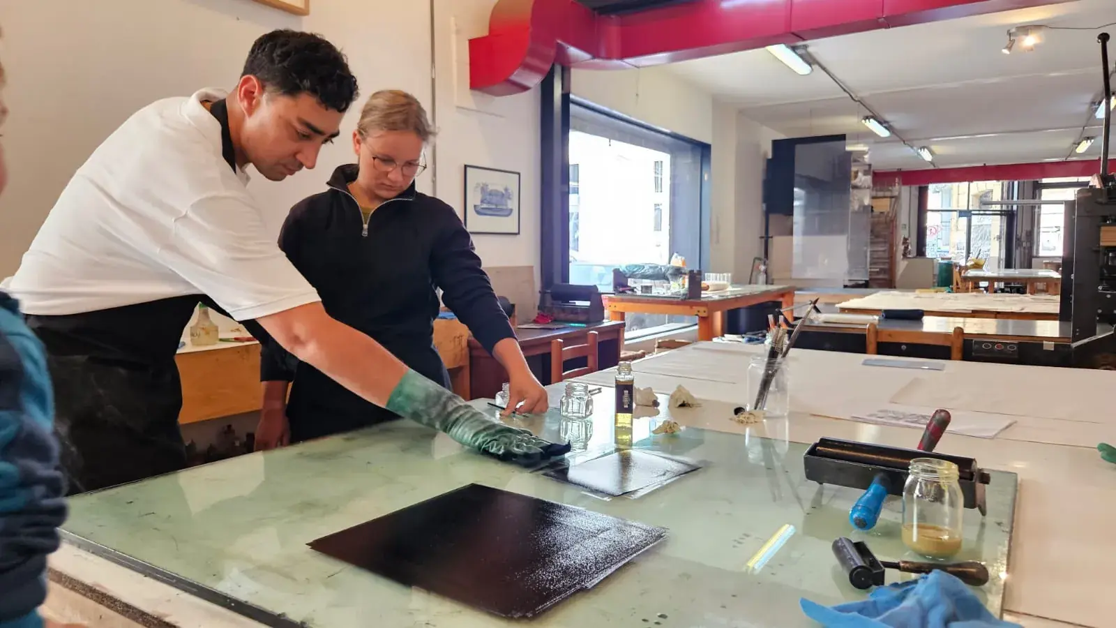 Printmaking workshop at CasaPlan in Valparaiso showing the printing process