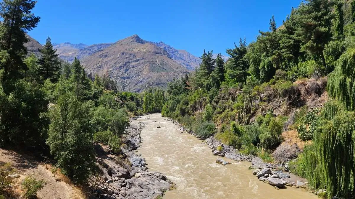 Maipo River winding through the Cajón del Maipo canyon with the Andes Mountains in the background