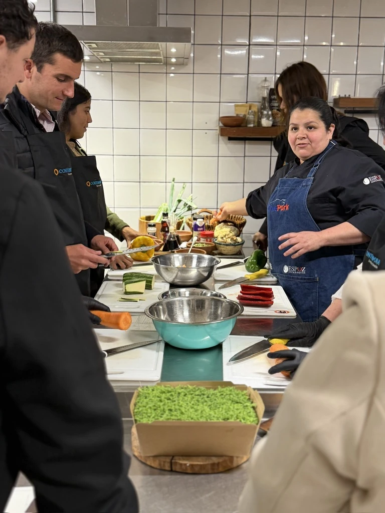 Chef explaining Chilean cooking techniques in a kitchen studio
