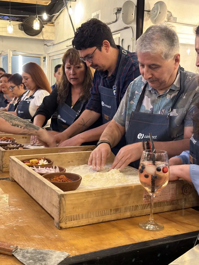 Guests kneading empanada dough during a Chilean cooking class