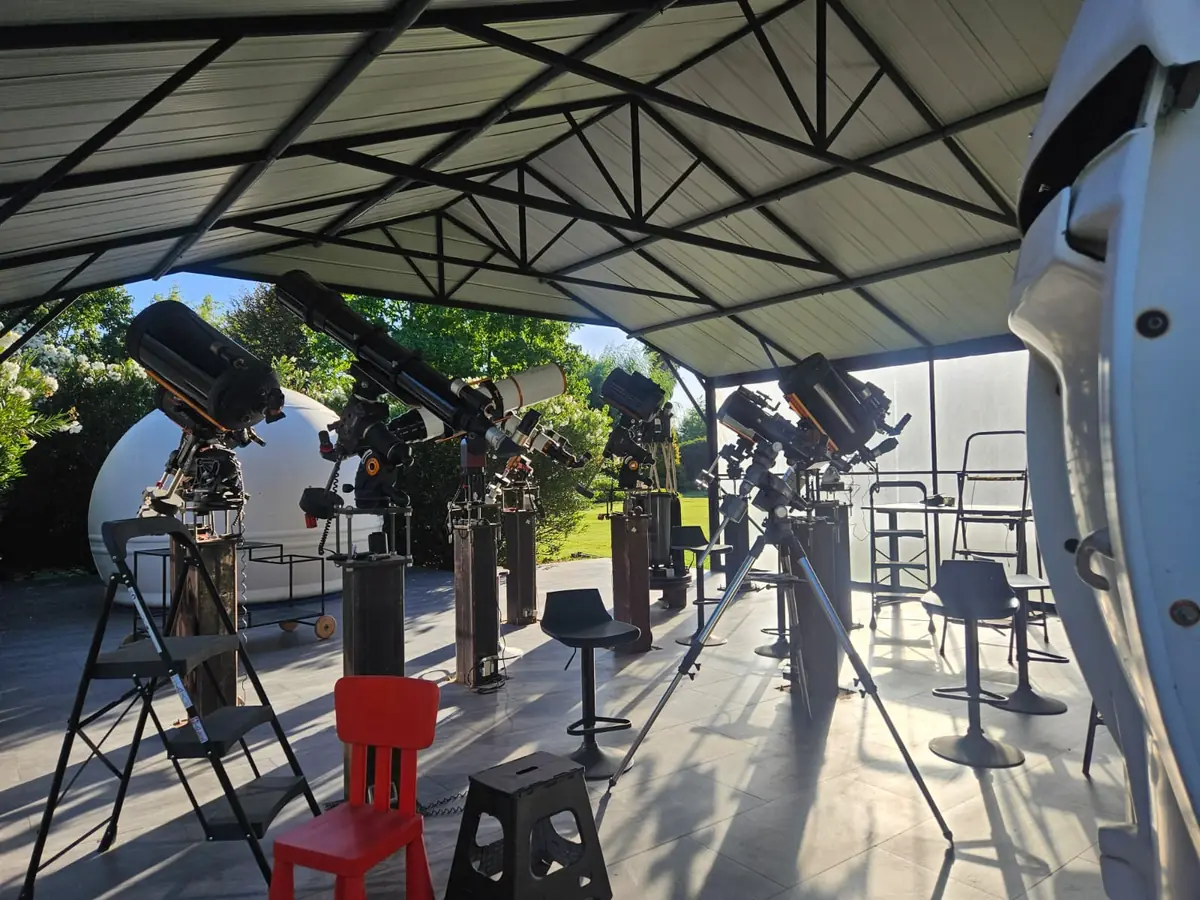 Row of telescopes under the canopy at the private observatory near Santiago