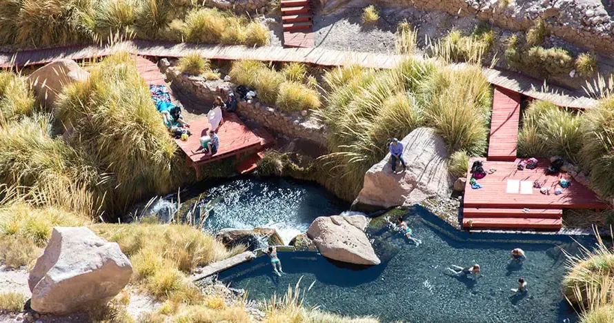 Natural warm pools of Puritama Hot Springs in a mountain canyon