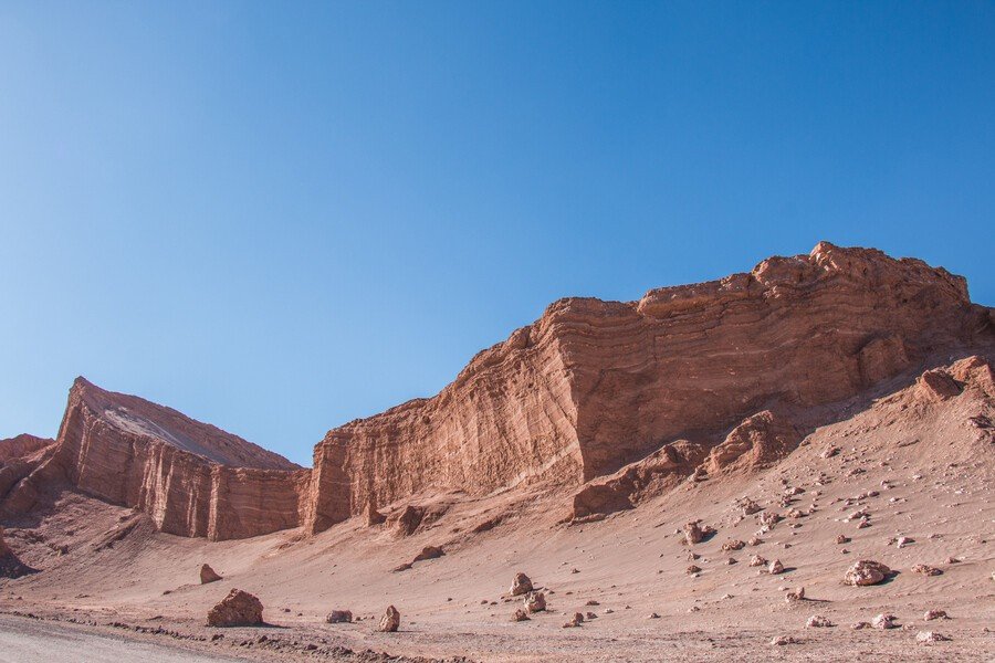 Layered rock walls of Moon Valley under a deep blue sky