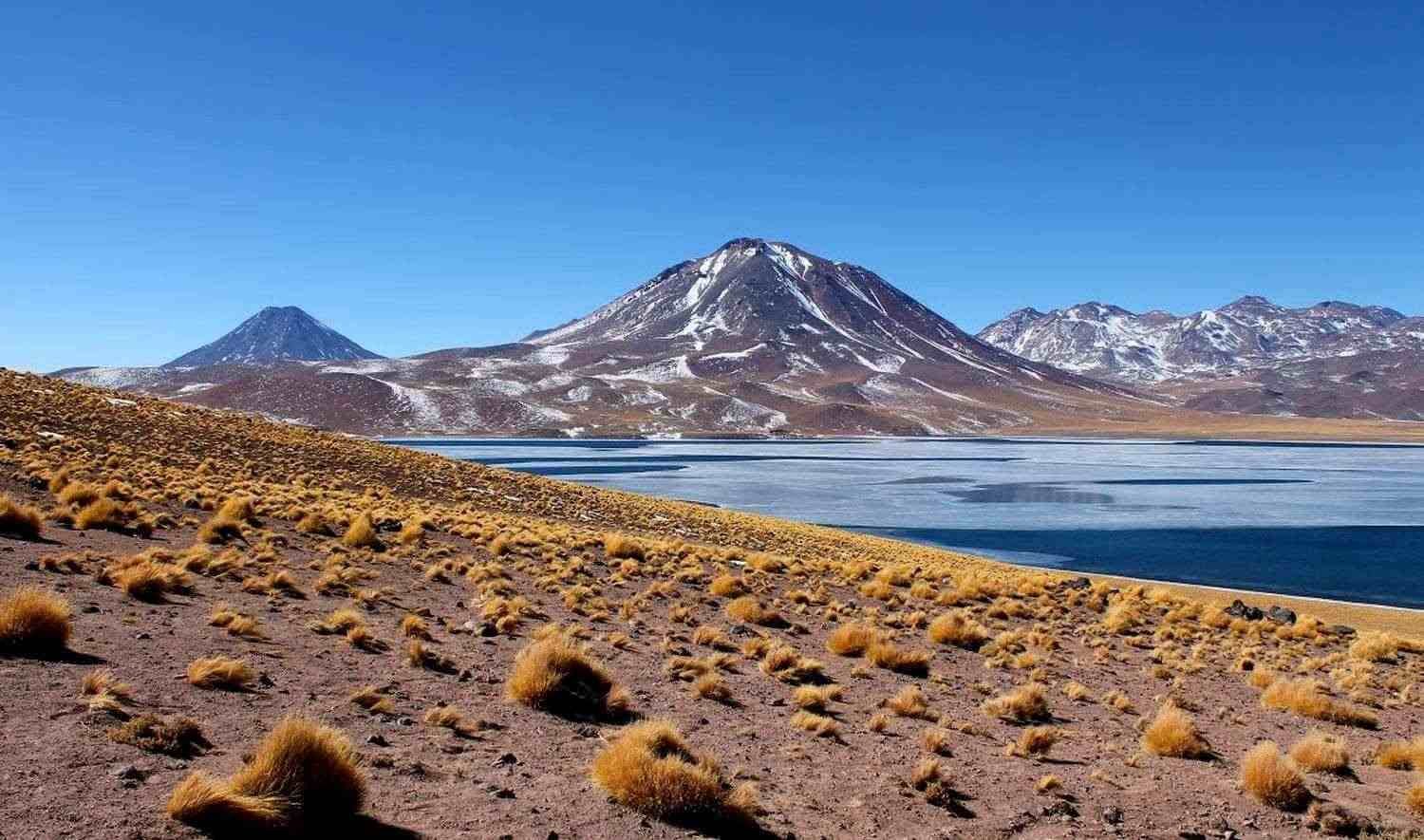 Deep blue Miscanti Lagoon below the cone of Miscanti volcano