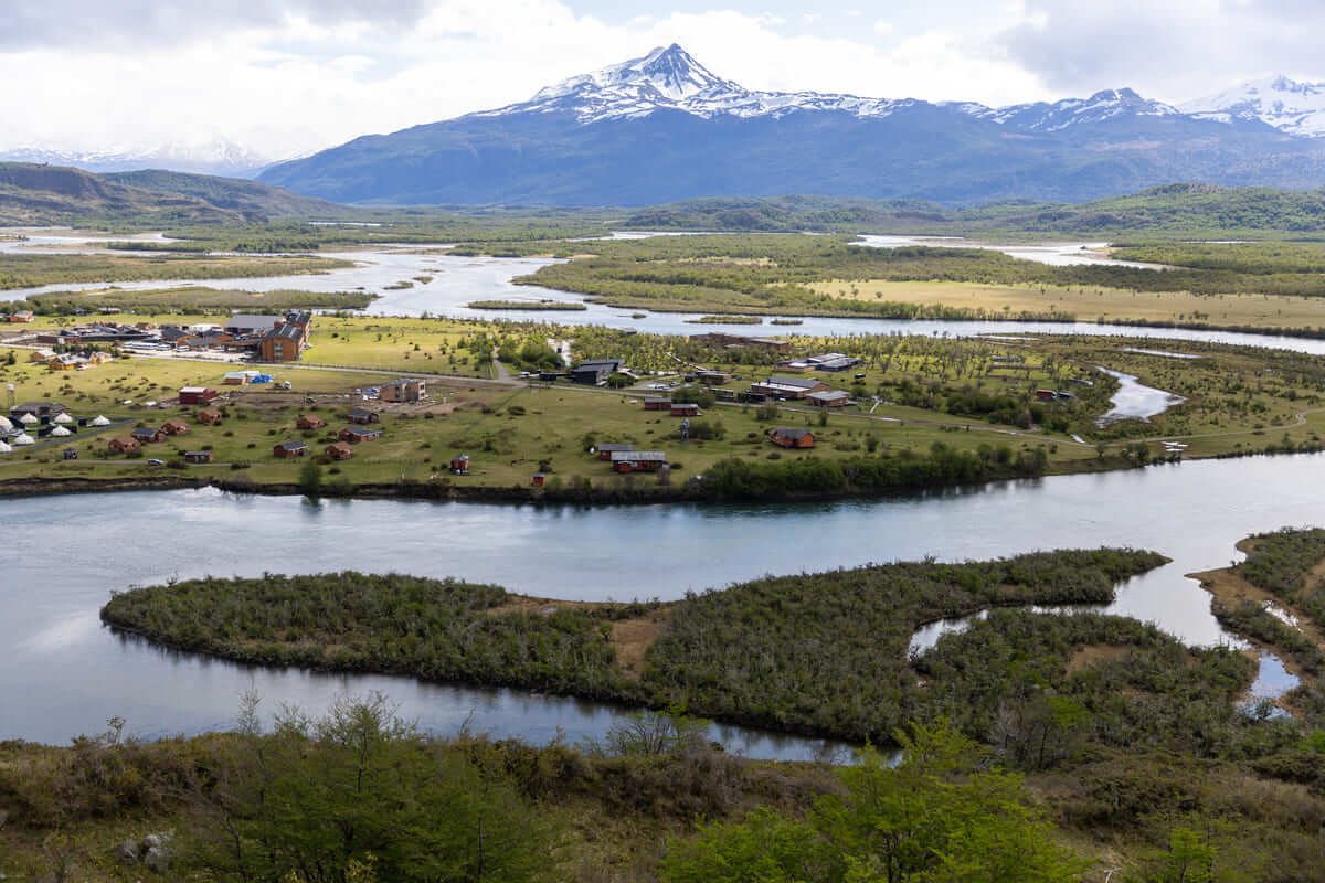 Braided channels of the Serrano River and village with snowy peaks behind