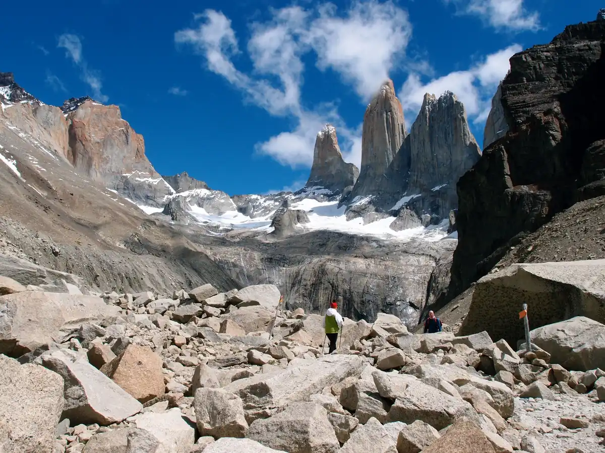 Trekkers crossing the boulder field on the final stretch to Base Las Torres