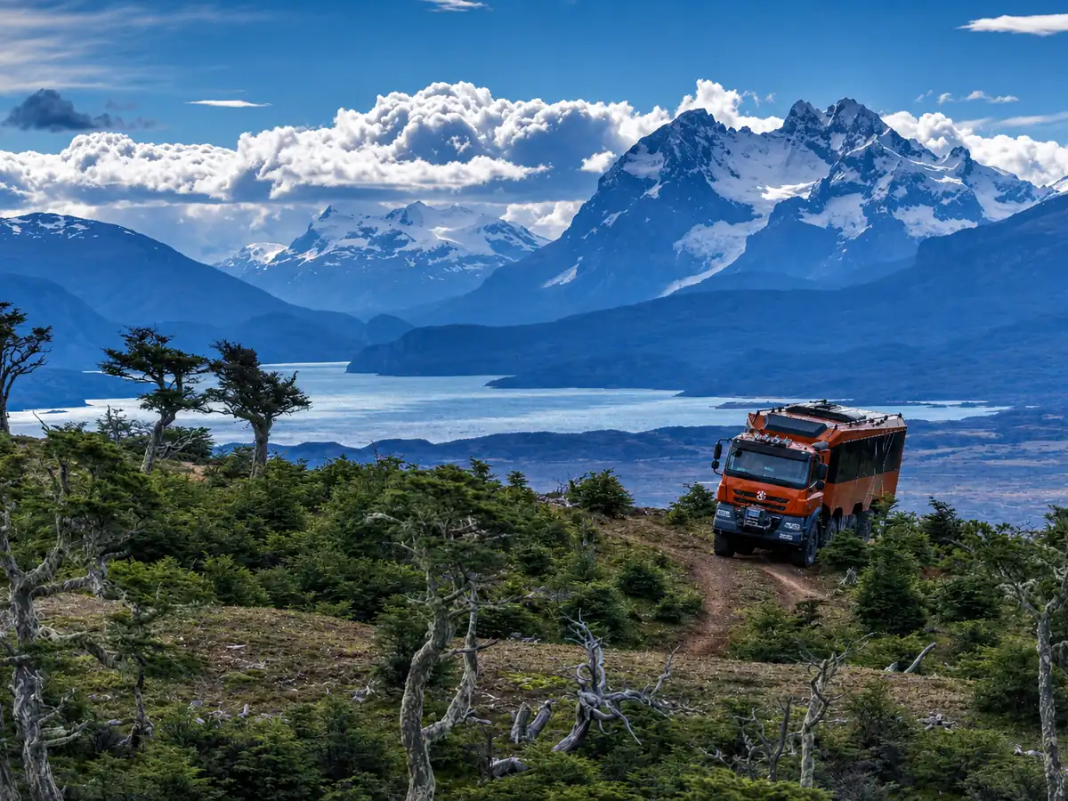 Off-road truck climbing Cerro Dorotea above the fjords of Ultima Esperanza