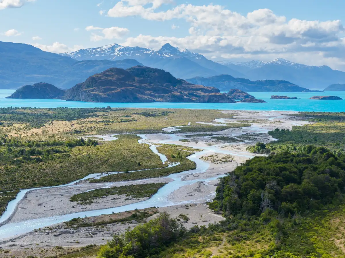 Glacial river winding into turquoise Lake General Carrera in Chilean Patagonia