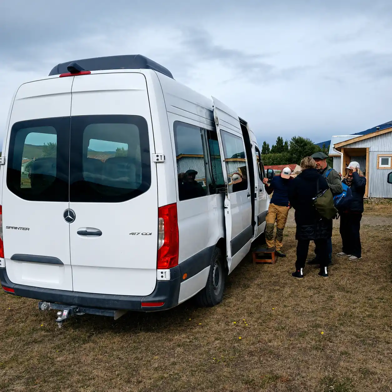 Travelers boarding a Mercedes Sprinter minibus for the private transfer from Torres del Paine to El Calafate